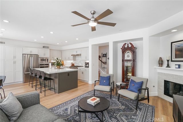a living room with furniture kitchen view and a fireplace
