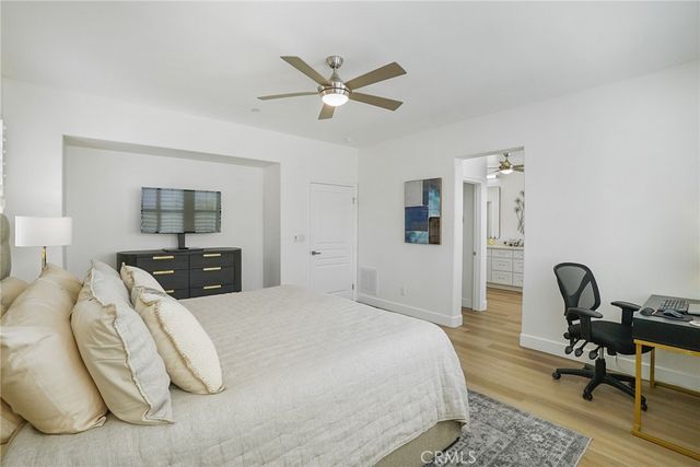 a bedroom with a bed and a desk