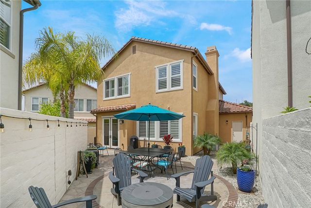 a view of a patio with table and chairs under an umbrella