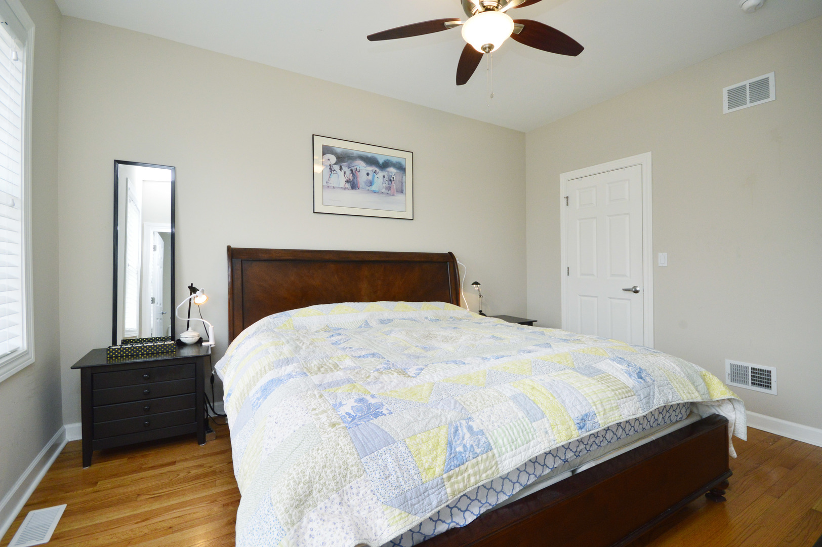 1631 Church Street Evanston, IL 60201 - Photo 11 of 19 a bedroom with a bed and a chandelier