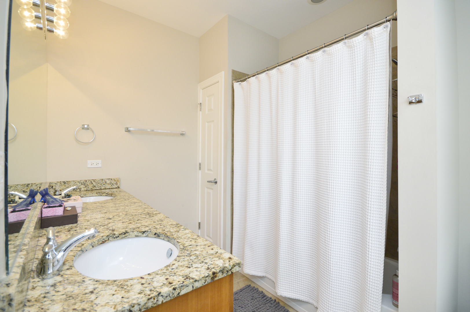 1631 Church Street Evanston, IL 60201 - Photo 18 of 19 a bathroom with a granite countertop sink and a mirror
