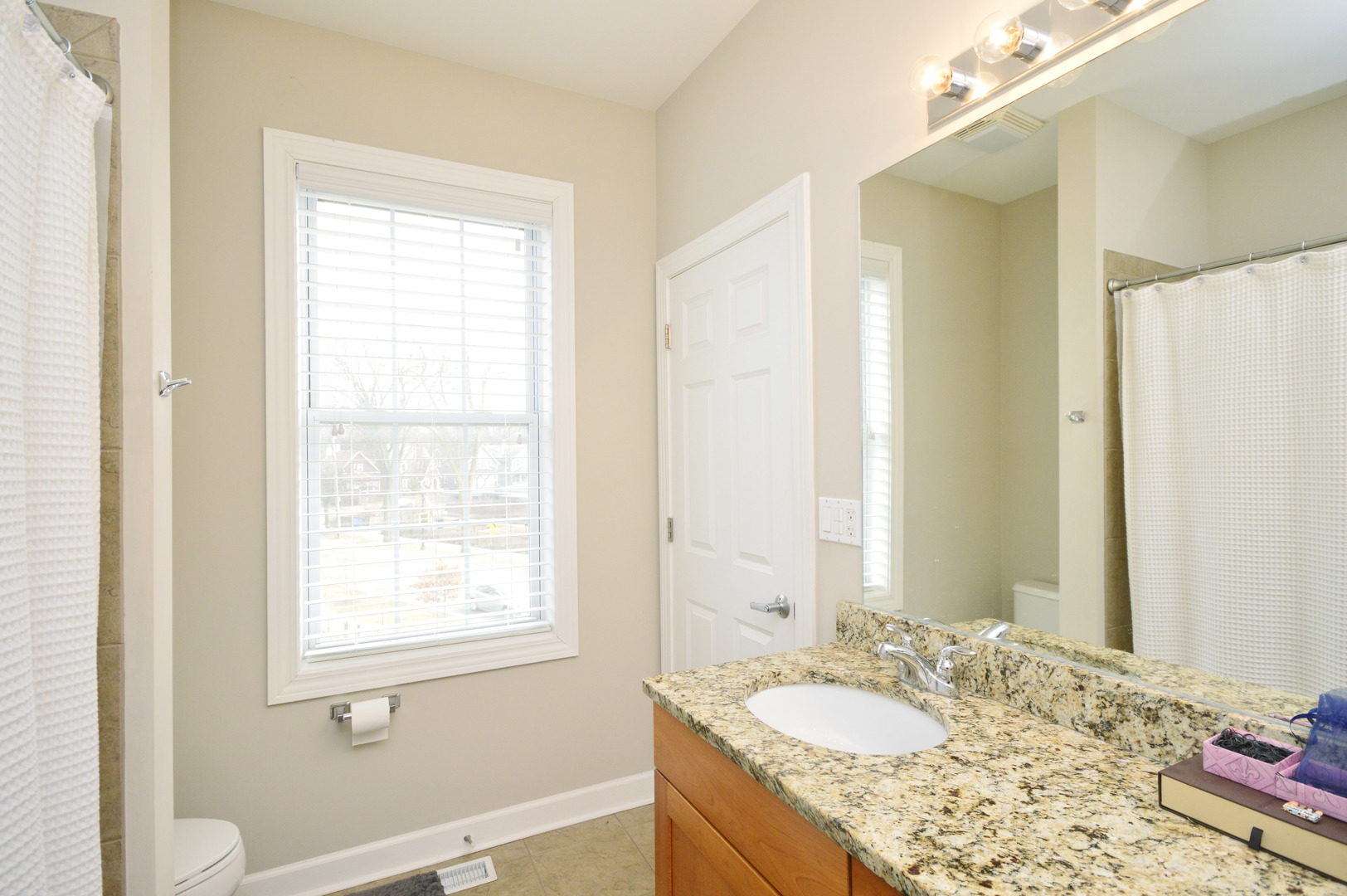 1631 Church Street Evanston, IL 60201 - Photo 19 of 19 a bathroom with a granite countertop sink and a mirror