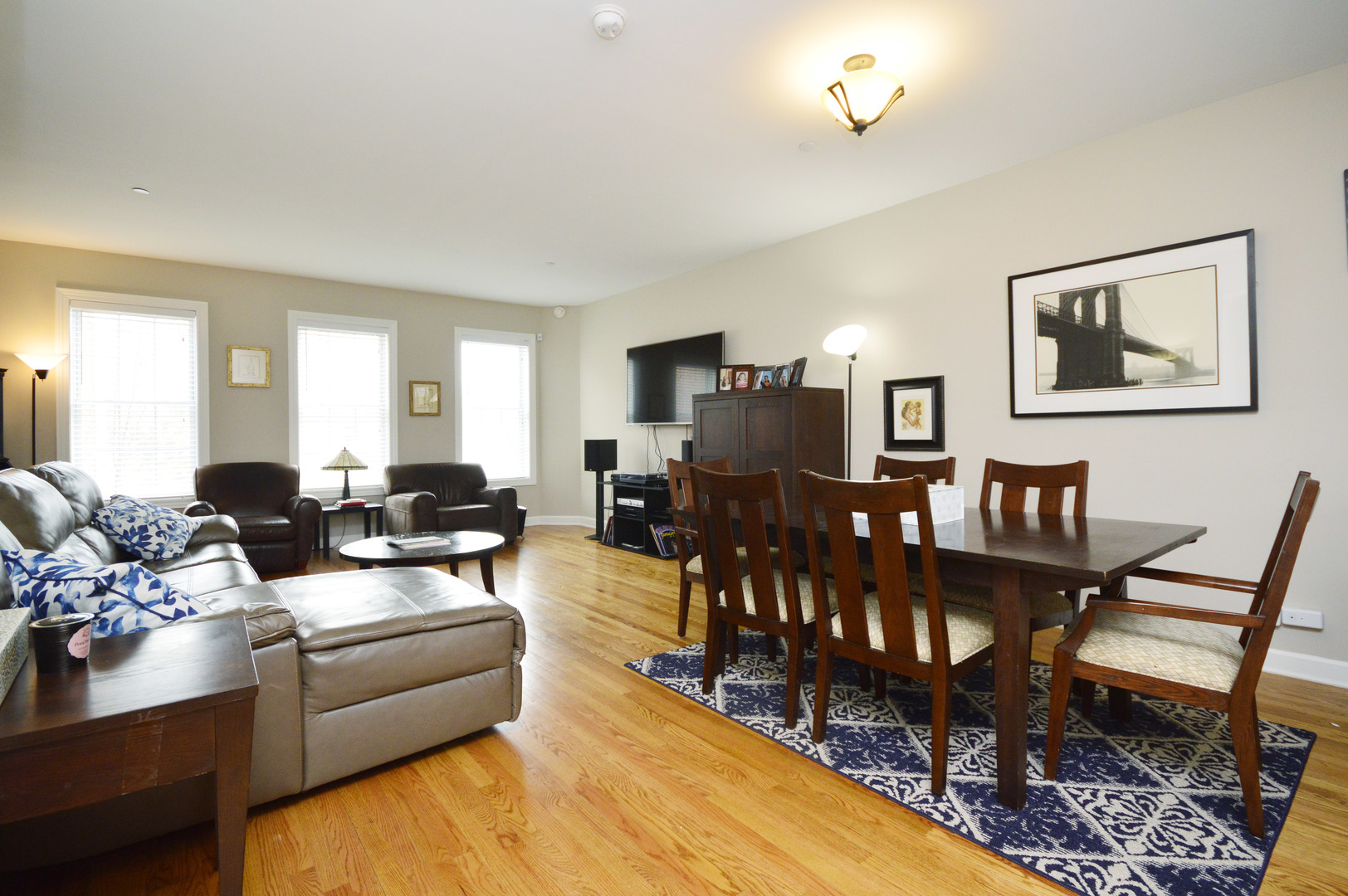 1631 Church Street Evanston, IL 60201 - Photo 4 of 19 a living room with furniture a rug and a chandelier