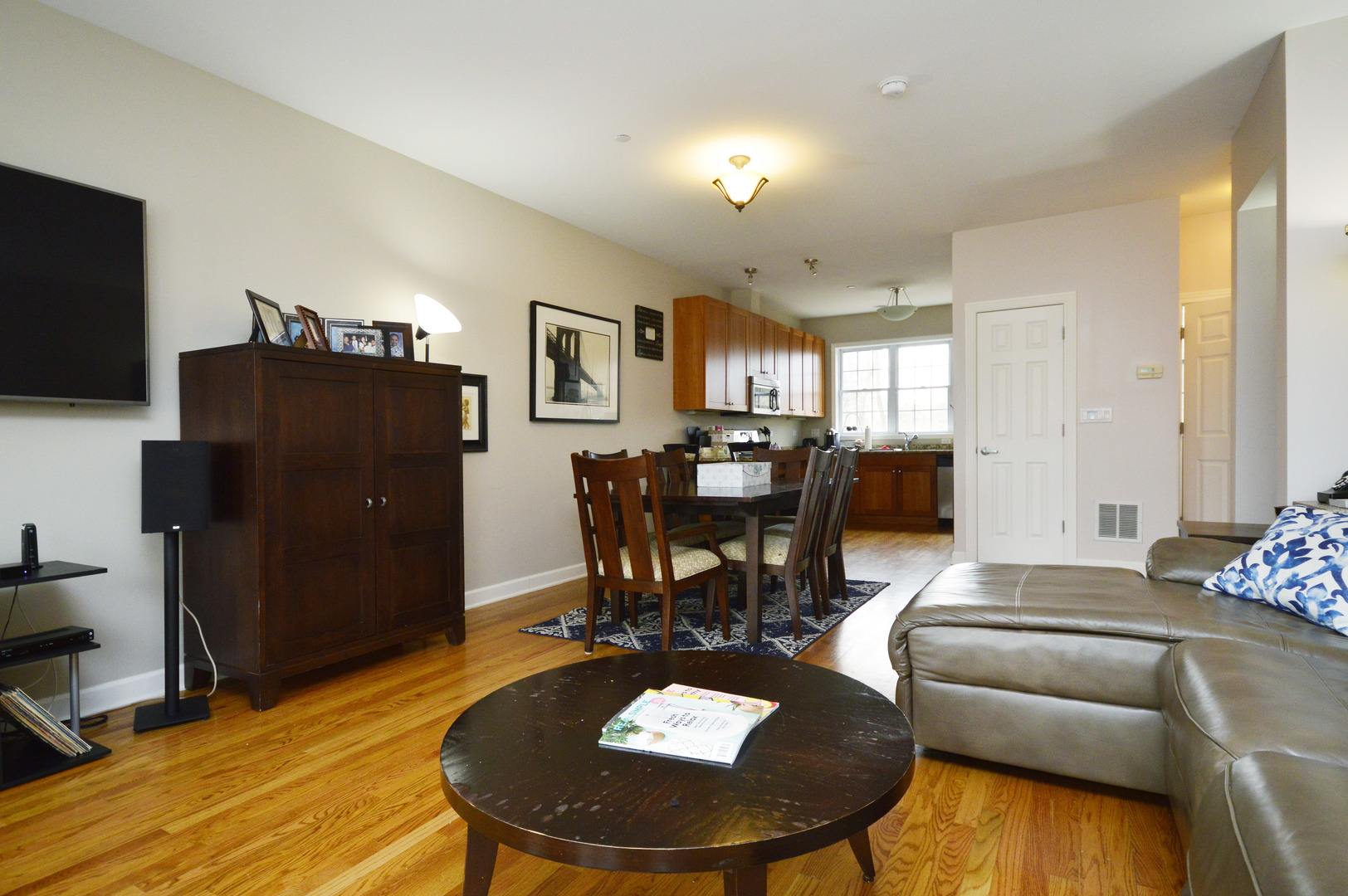 1631 Church Street Evanston, IL 60201 - Photo 6 of 19 a living room with furniture a flat screen tv and a dining table
