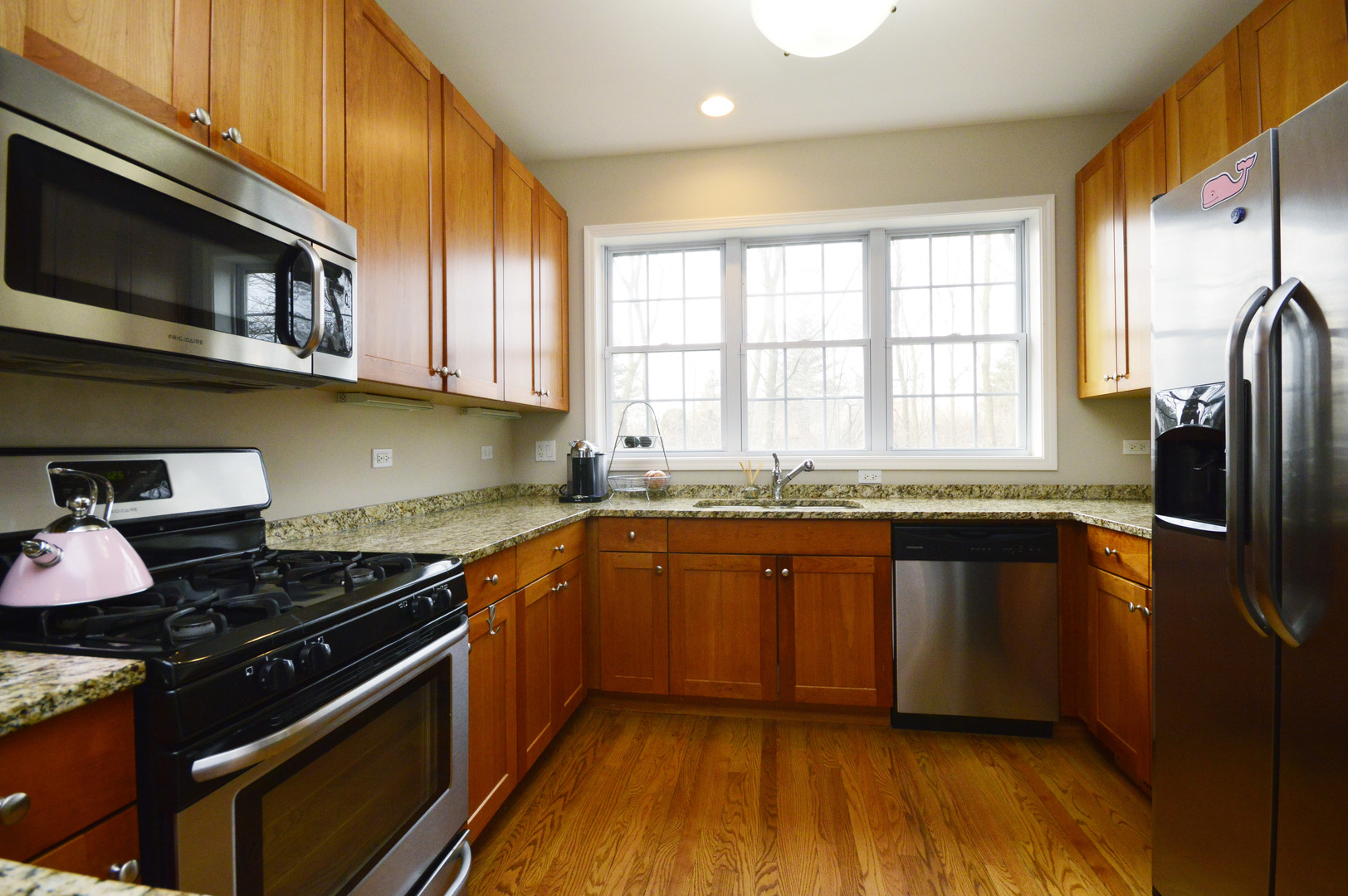 1631 Church Street Evanston, IL 60201 - Photo 7 of 19 a kitchen with stainless steel appliances granite countertop a stove a sink and a microwave