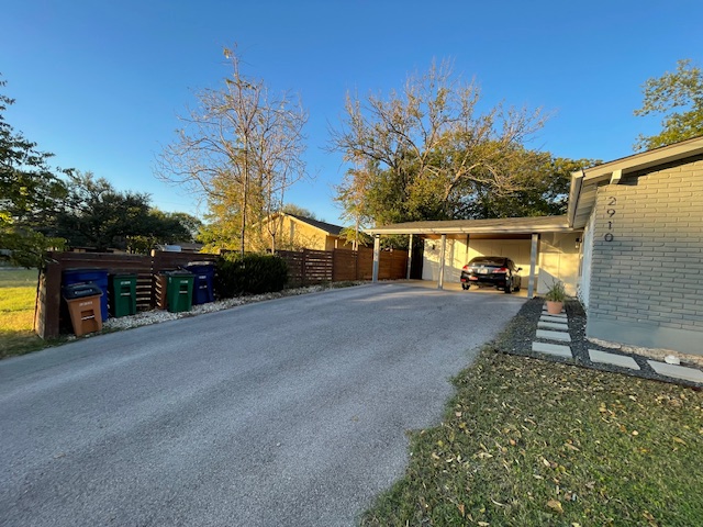 2910 Pecan Springs Road, Unit A Austin, TX 78723 - Photo 3 of 39 View of property exterior featuring a carport & driveway.