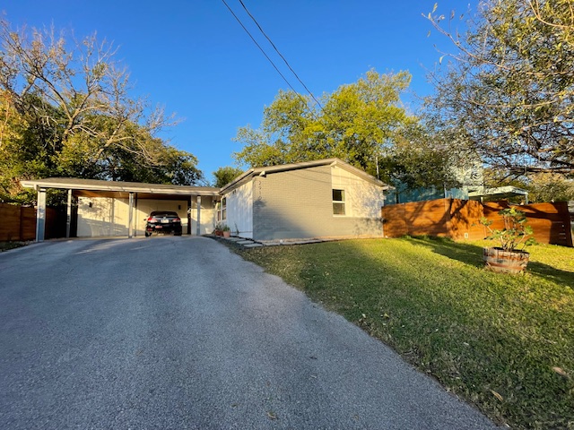 2910 Pecan Springs Road, Unit A Austin, TX 78723 - Photo 6 of 39 View of home's exterior featuring driveway and an attached carport