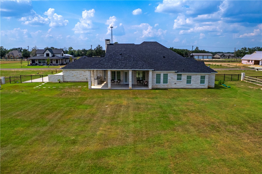 7844 Mathis Crk Drive Bryan, TX 77808 - Photo 41 of 41 Rear view of property featuring a fenced backyard, a patio area, a chimney, and roof with shingles