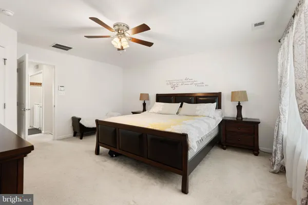 a bedroom with a bed and ceiling fan