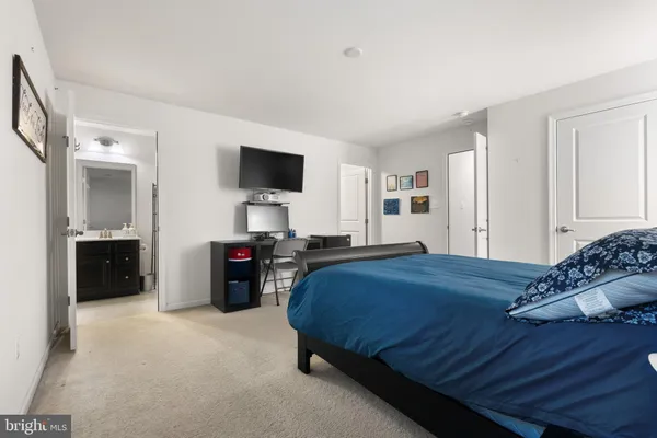 a bedroom with a bed and a flat tv screen