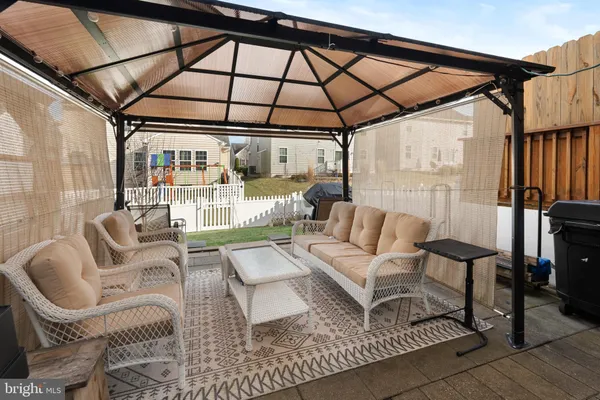 a living room with furniture and a ceiling fan