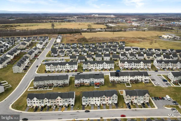 an aerial view of residential houses with outdoor space