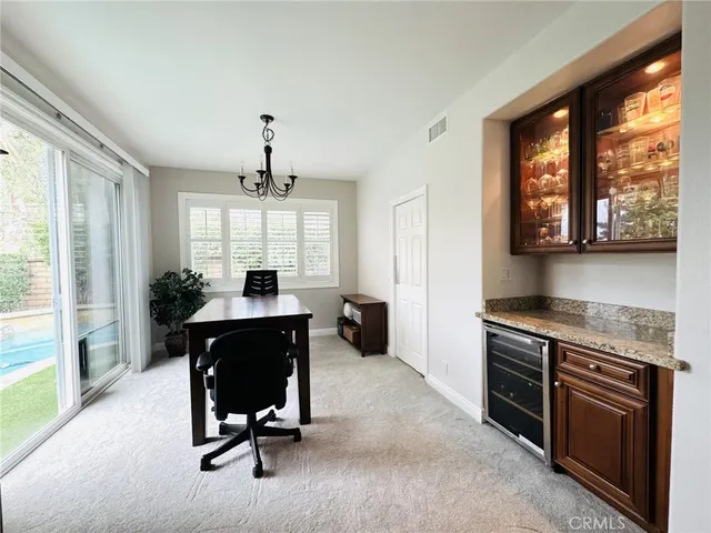a view of a livingroom with workspace and a window