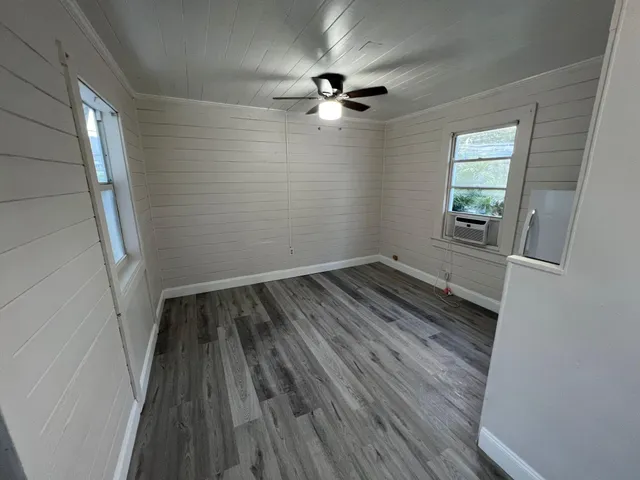 wooden floor in an empty room with a window