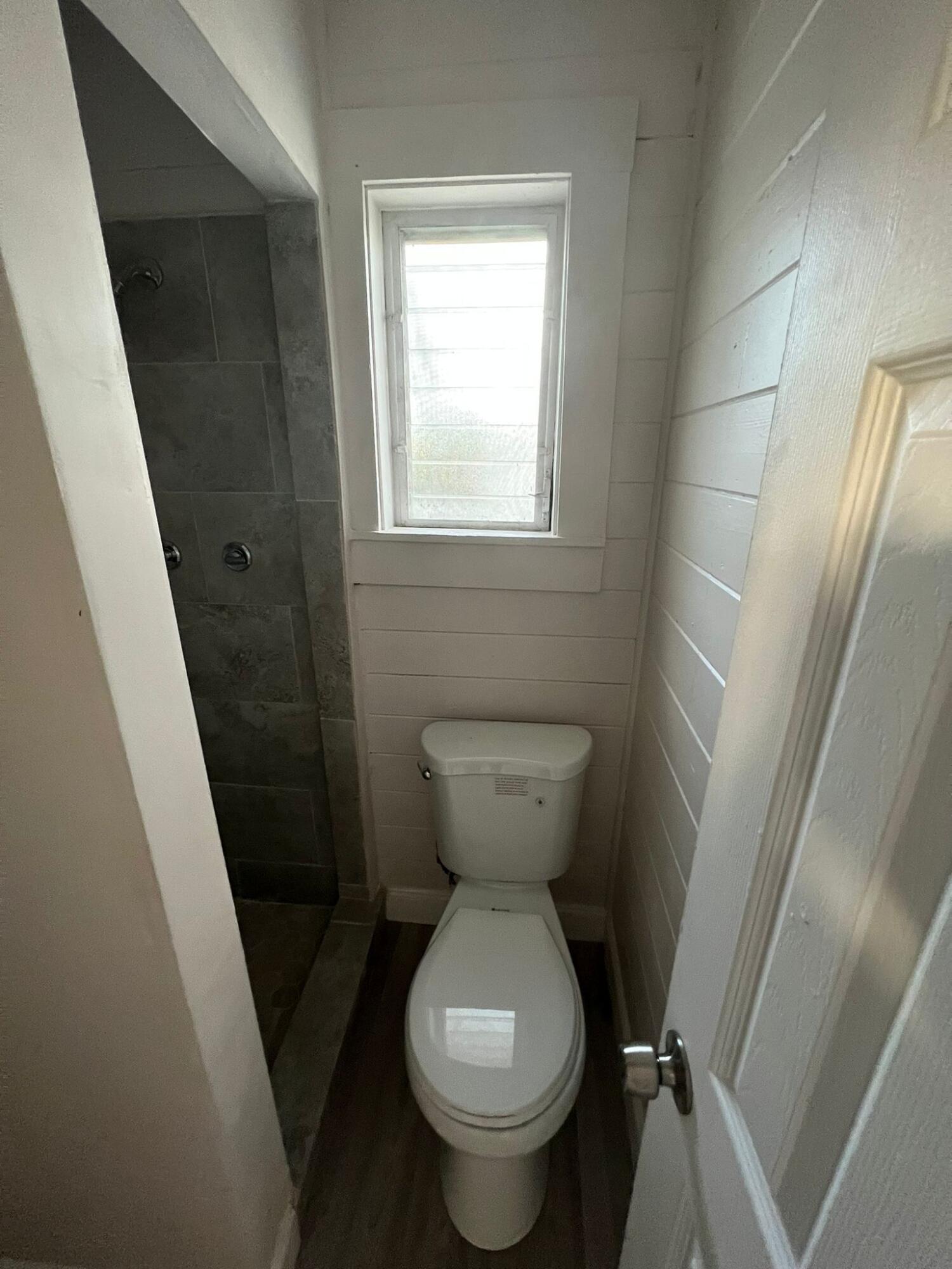 2843 Forest Hill Boulevard, Unit 7 Palm Springs, FL 33406 - Photo 5 of 8 a bathroom with a toilet and a sink