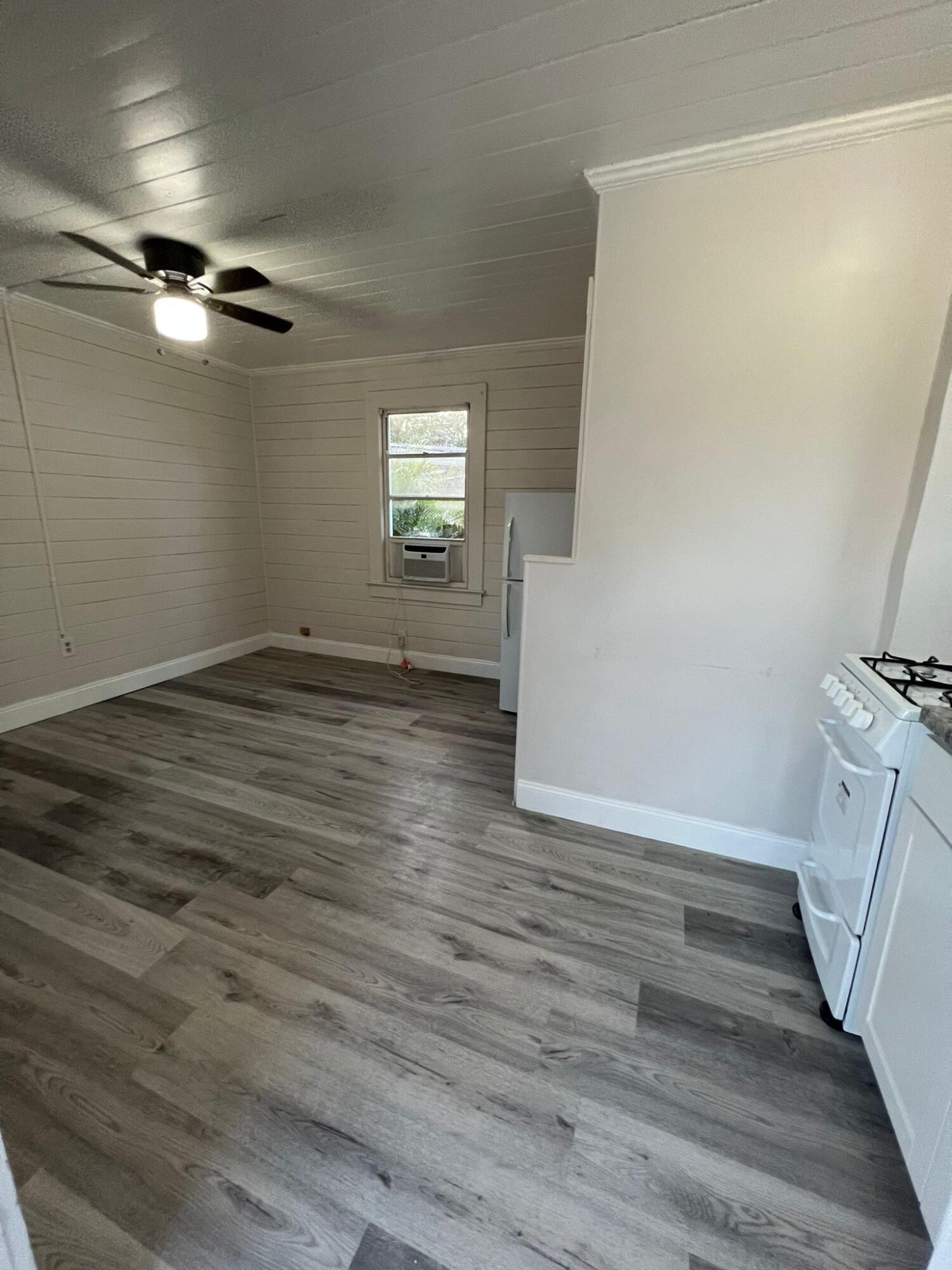 2843 Forest Hill Boulevard, Unit 7 Palm Springs, FL 33406 - Photo 8 of 8 wooden floor in an empty room with a window