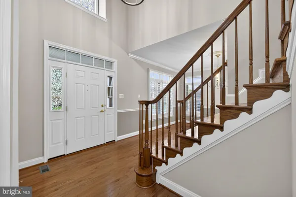 a view of a livingroom with a dinning area furniture and wooden floor