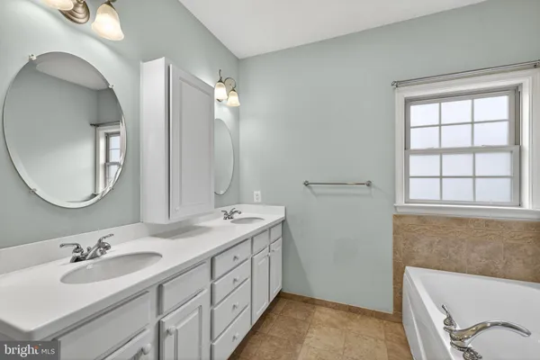 a view of a back yard with brick wall and potted plants