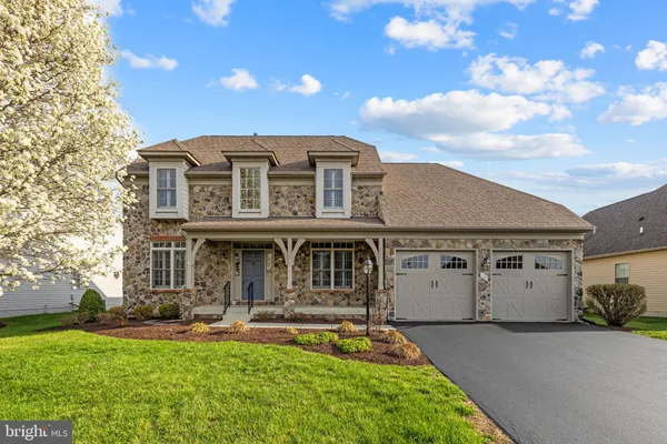 a view of a house with a yard balcony and sitting area