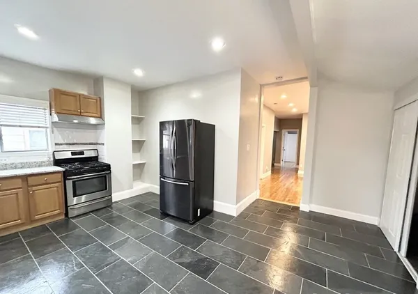 a kitchen with stainless steel appliances a refrigerator and a stove top oven