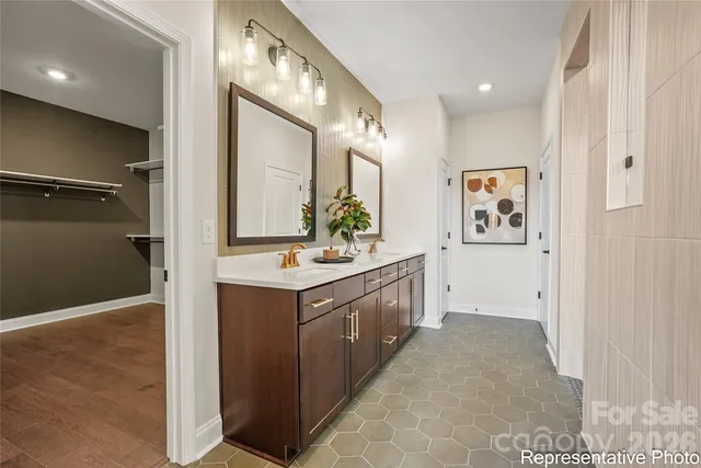 a bathroom with a double vanity sink mirror and toilet