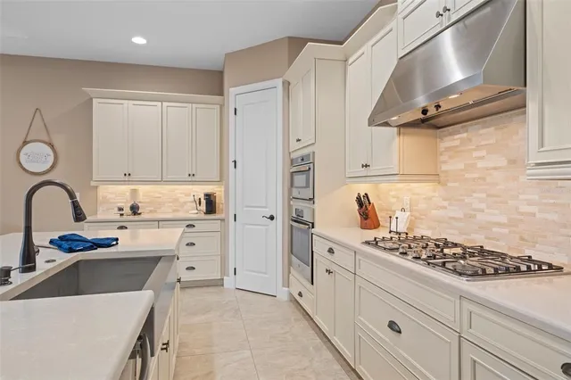 a view of a dining room with furniture a chandelier and wooden floor