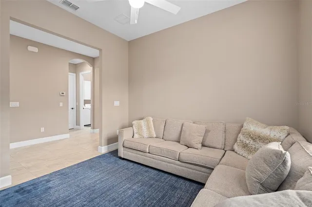 a large white kitchen with a large window and stainless steel appliances