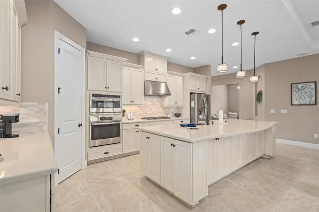 a living room with furniture a flat screen tv and a large window