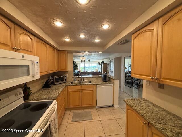 1305 South Atlantic Avenue, Unit 120 Cocoa Beach, FL 32931 - Photo 3 of 10 a kitchen with stainless steel appliances granite countertop a sink stove and cabinets