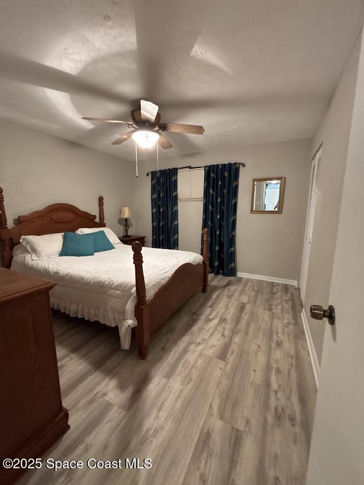 1305 South Atlantic Avenue, Unit 120 Cocoa Beach, FL 32931 - Photo 9 of 10 a bedroom with a bed and a ceiling fan