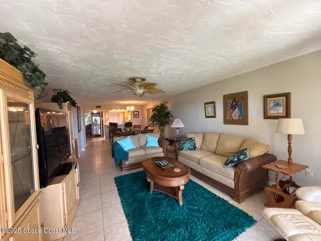 a living room with furniture a rug and a flat screen tv