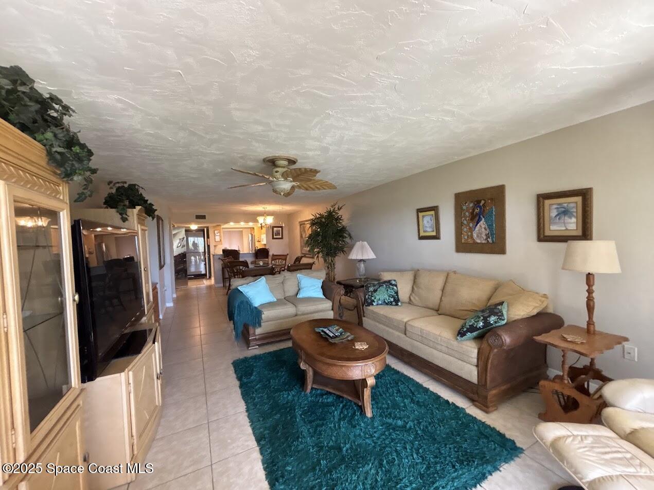 1305 South Atlantic Avenue, Unit 120 Cocoa Beach, FL 32931 - Photo 10 of 10 a living room with furniture a rug and a flat screen tv