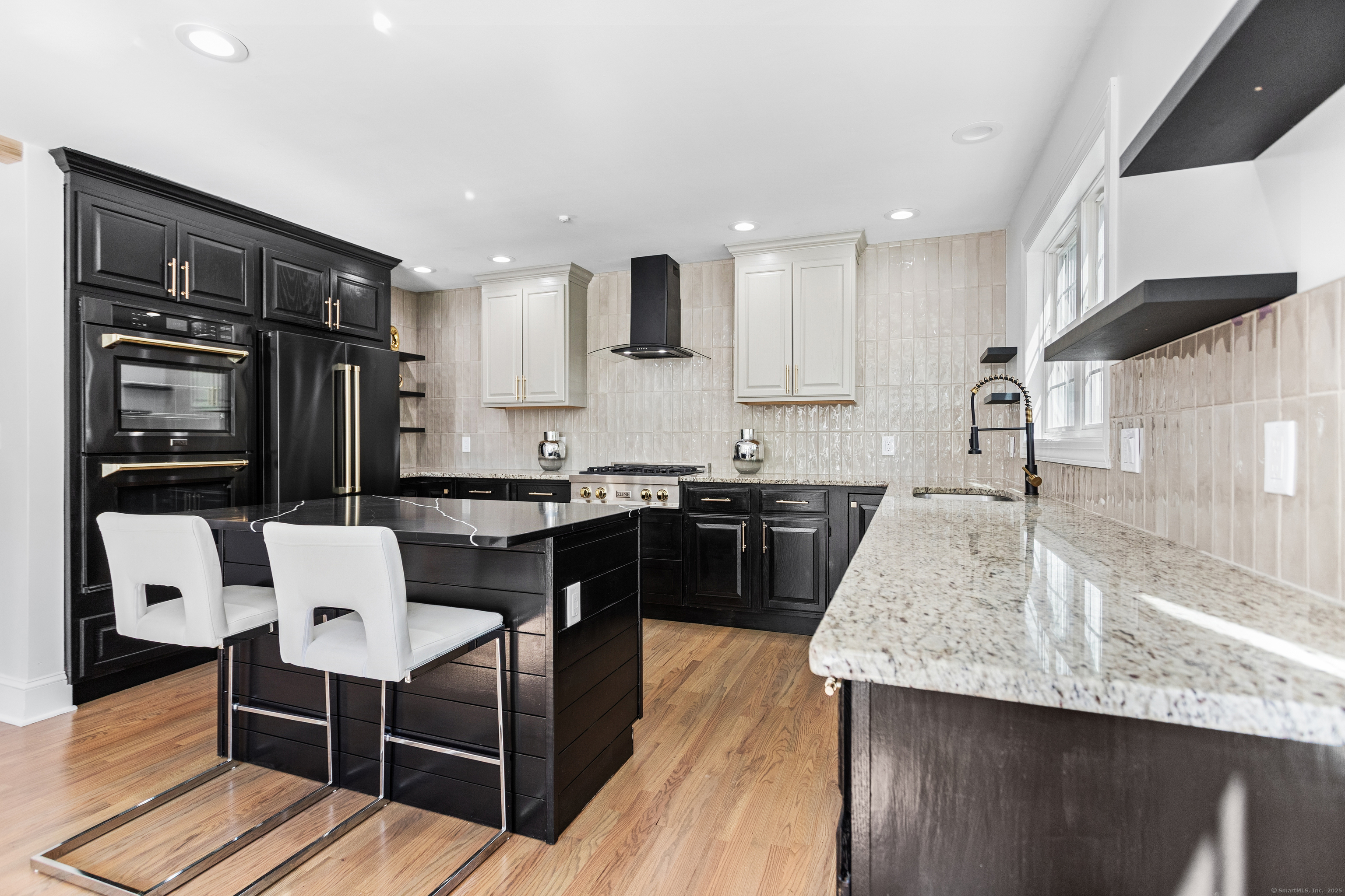 61 Edgewater Commons Lane Westport, CT 06880 - Photo 12 of 37 a kitchen with granite countertop kitchen island stainless steel appliances a sink and a refrigerator