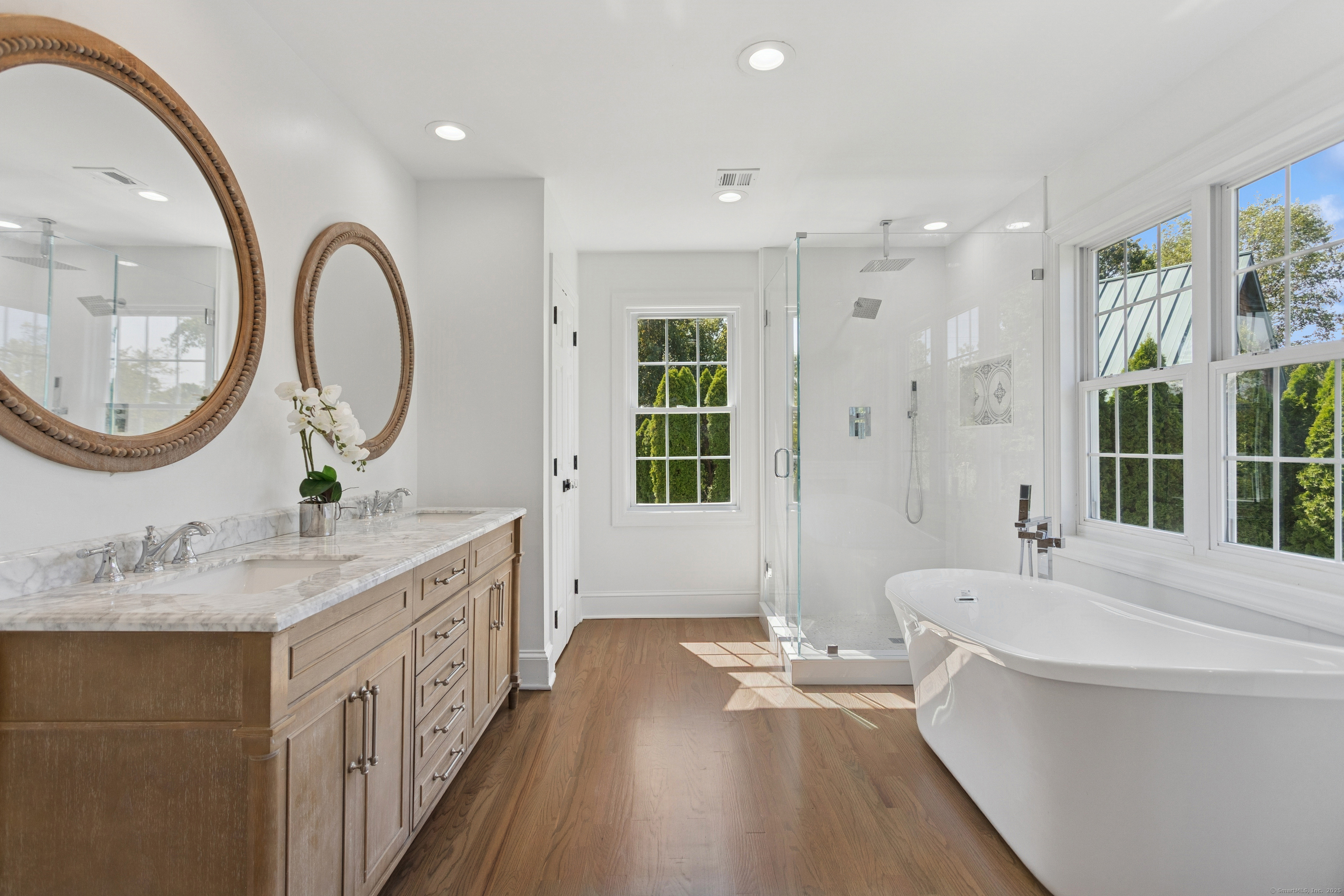 61 Edgewater Commons Lane Westport, CT 06880 - Photo 17 of 37 a bathroom with a granite countertop sink a mirror and a bathtub
