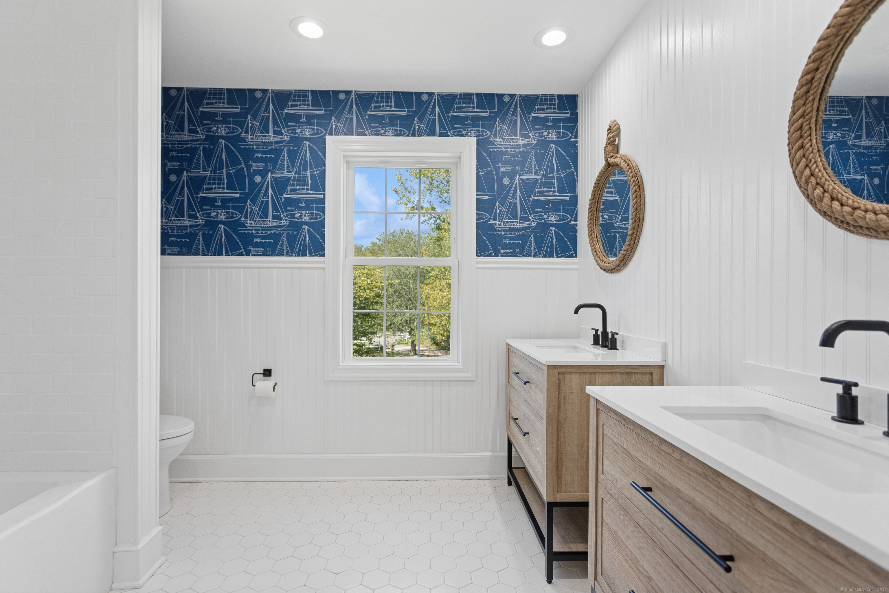 61 Edgewater Commons Lane Westport, CT 06880 - Photo 24 of 37 a bathroom with a sink and a mirror