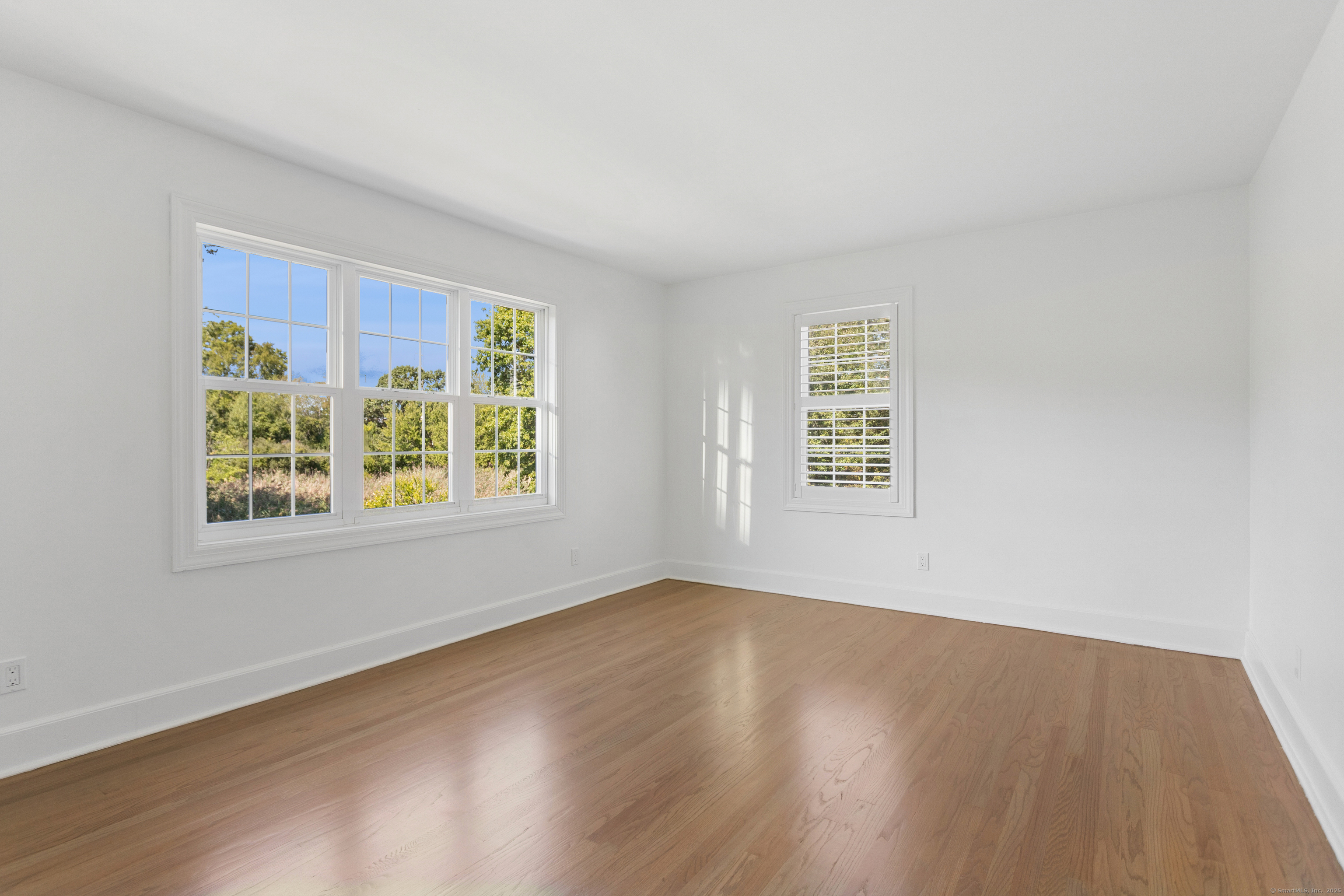 61 Edgewater Commons Lane Westport, CT 06880 - Photo 26 of 37 a view of an empty room with wooden floor and a window