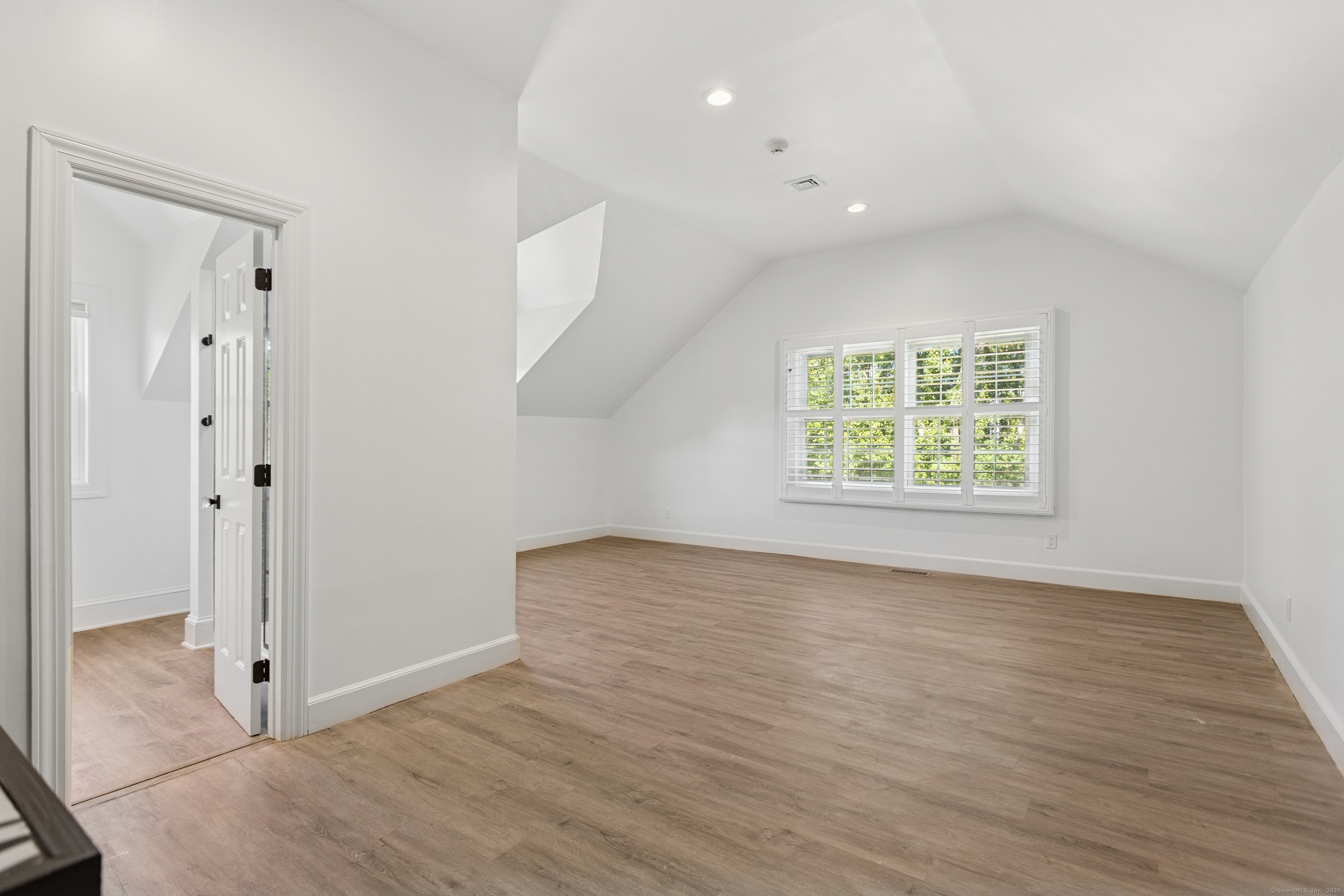 61 Edgewater Commons Lane Westport, CT 06880 - Photo 27 of 37 an empty room with wooden floor and window