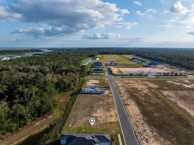 an aerial view of a residential houses with city view
