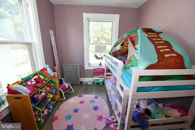 a bedroom with furniture and a wooden floor