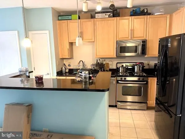 a kitchen with stainless steel appliances a sink counter space and a window