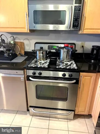 a stove top oven sitting inside of a kitchen