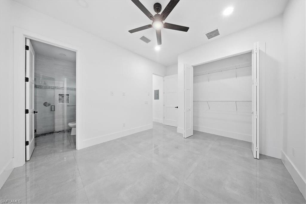3261 15th Avenue Southwest Naples, FL 34117 - Photo 11 of 20 Unfurnished bedroom with finished concrete flooring, a ceiling fan, a closet, and recessed lighting