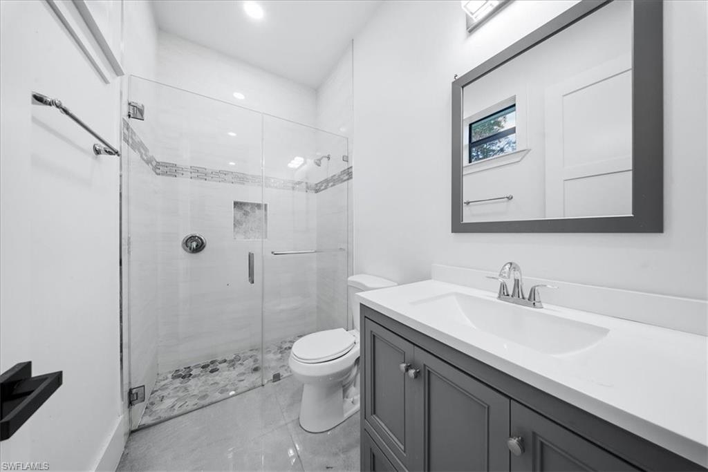 3261 15th Avenue Southwest Naples, FL 34117 - Photo 12 of 20 Full bathroom featuring a shower stall and vanity