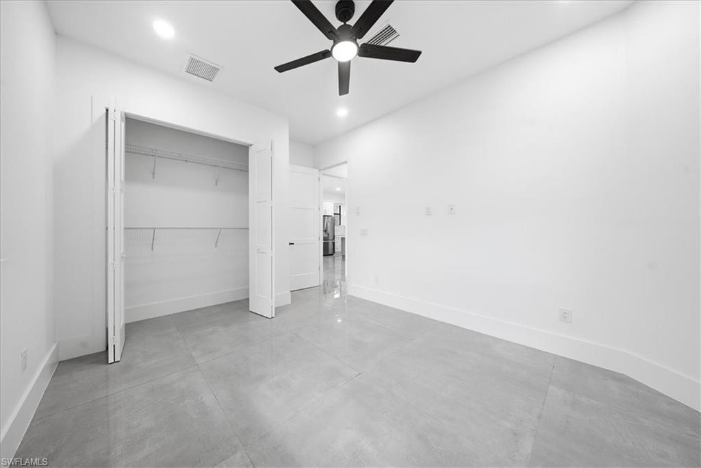3261 15th Avenue Southwest Naples, FL 34117 - Photo 13 of 20 Unfurnished bedroom with concrete flooring, ceiling fan, recessed lighting, and a closet