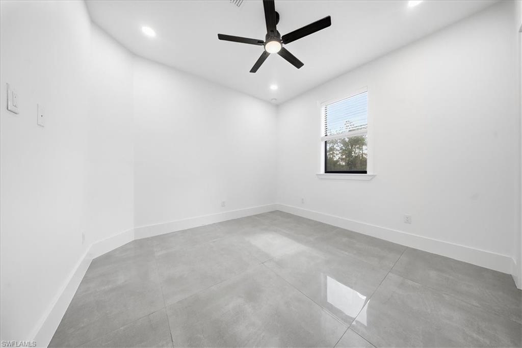 3261 15th Avenue Southwest Naples, FL 34117 - Photo 14 of 20 Spare room with concrete floors, a ceiling fan, and recessed lighting