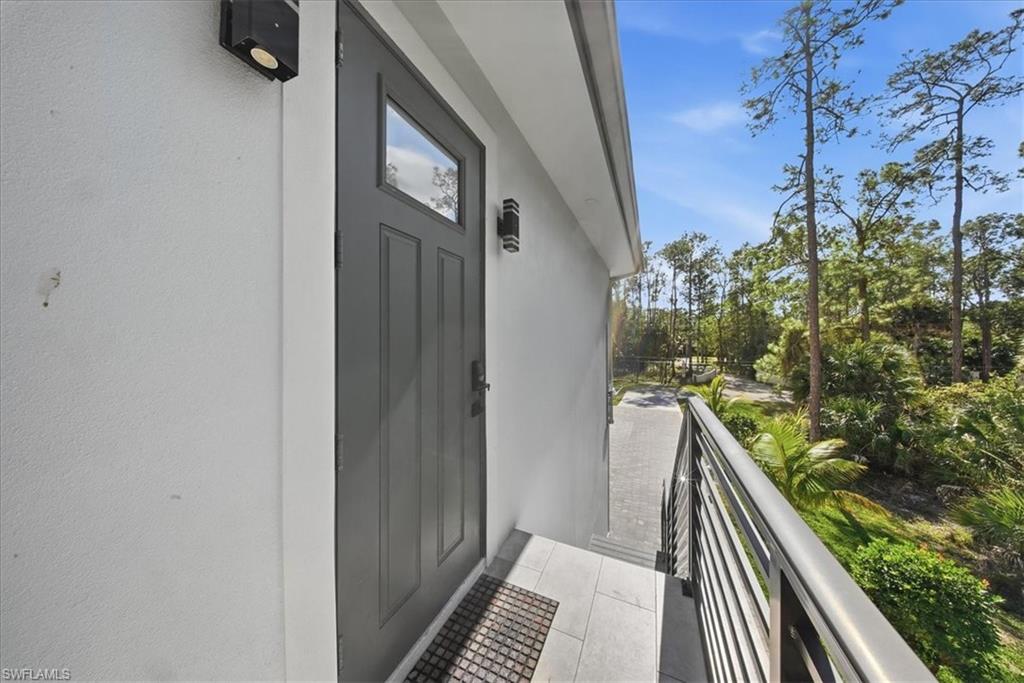 3261 15th Avenue Southwest Naples, FL 34117 - Photo 4 of 20 View of exterior entry with stucco siding