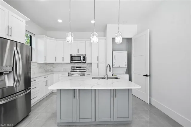 a kitchen with kitchen island a counter top space stainless steel appliances and cabinets