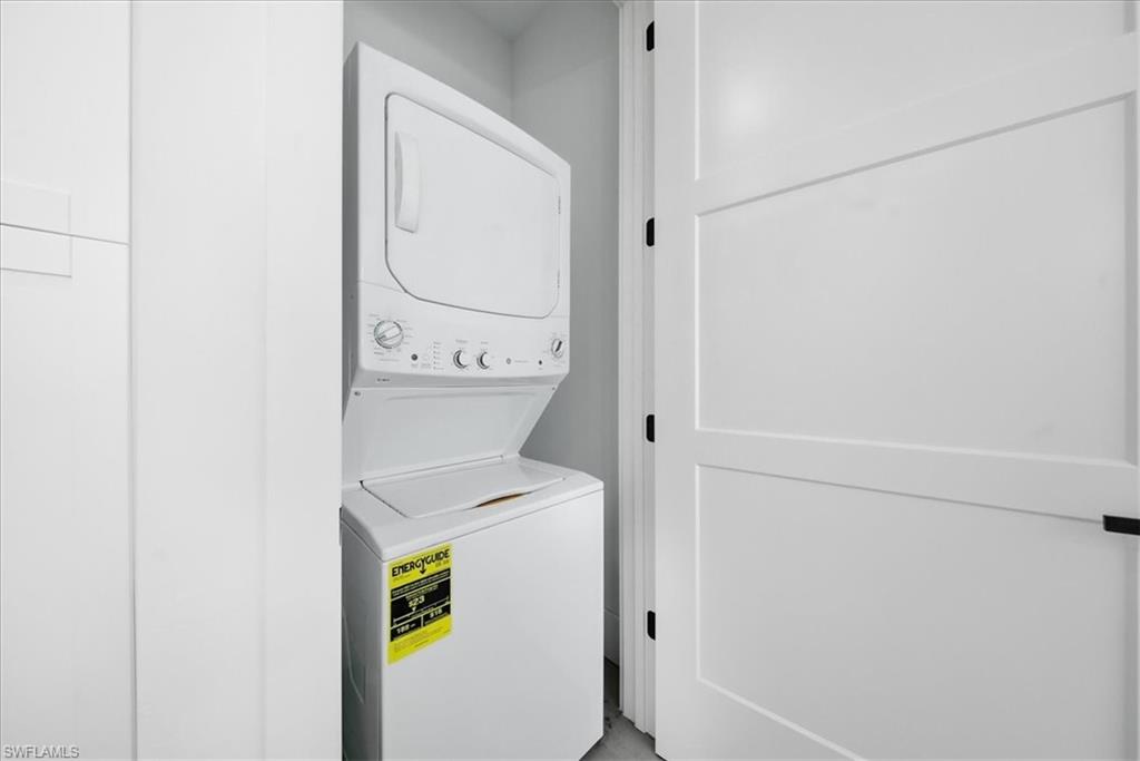 3261 15th Avenue Southwest Naples, FL 34117 - Photo 8 of 20 Laundry room featuring stacked washing machine and dryer