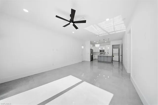 a view of a living room a window and a ceiling fan