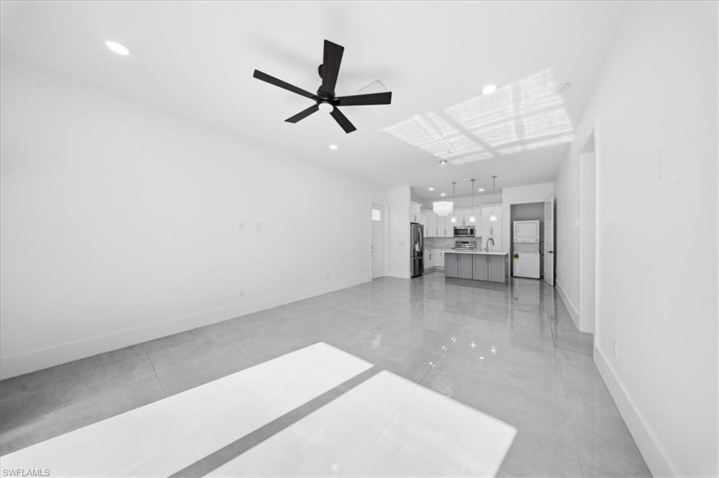 3261 15th Avenue Southwest Naples, FL 34117 - Photo 9 of 20 Unfurnished living room with ceiling fan and recessed lighting